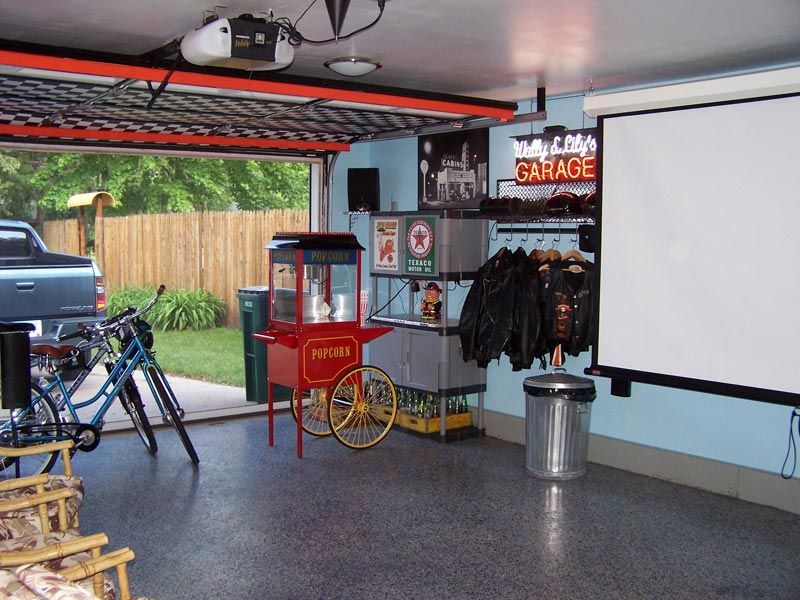 An example of a garage that's been converted into a home theater with a popcorn machine and large projector screen. 