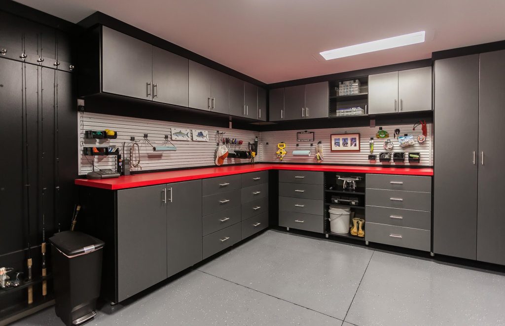 Grey custom cabinets installed in a garage for additional storage. 